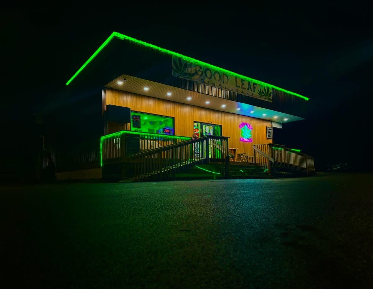 Good Leaf Dispensary at night, outlined in green lights on State Route 37
